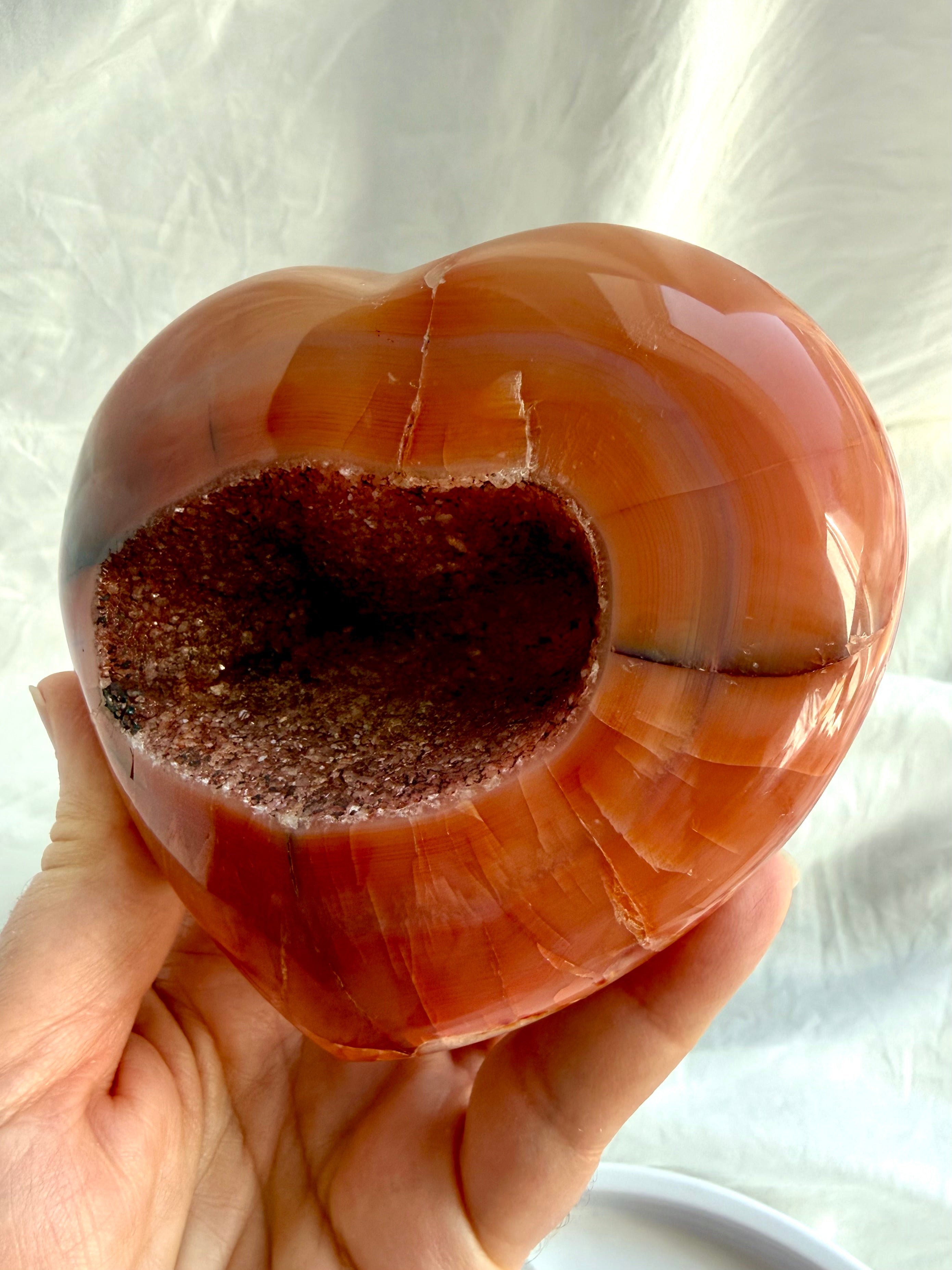 Opposite side of one of a kind Carnelian geode heart with polished red-orange patterns