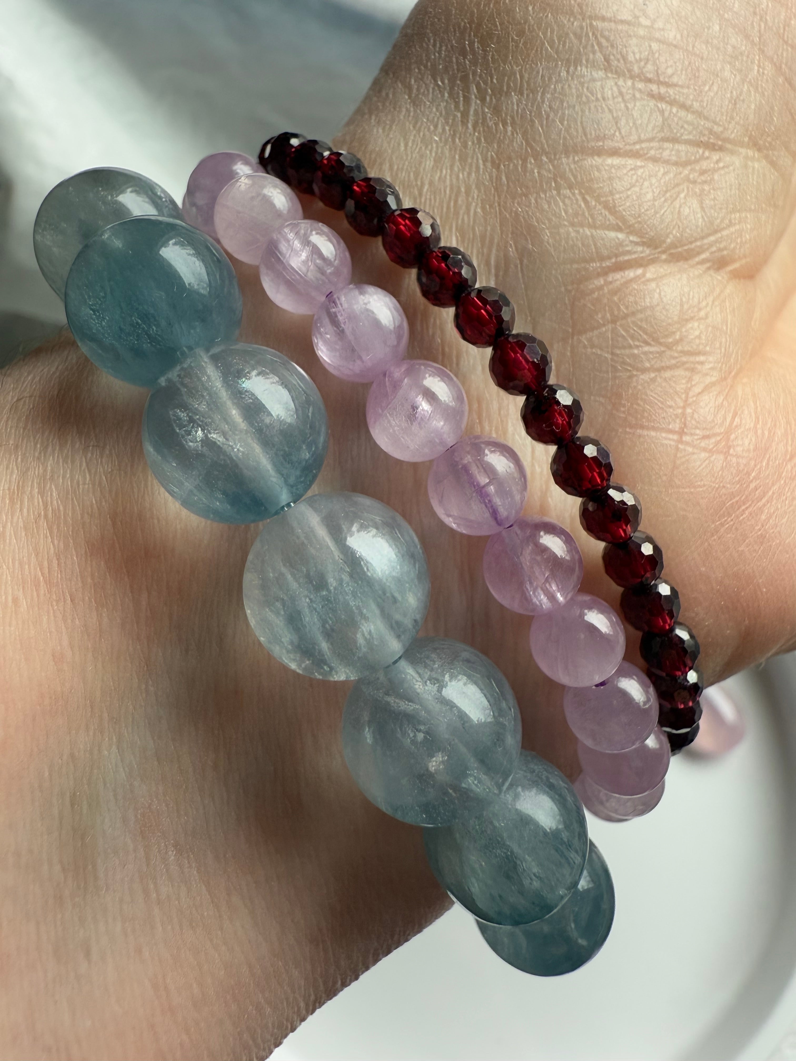 High quality faceted Almandine Garnet bracelet worn with Kunzite and silky blue fluorite bracelets