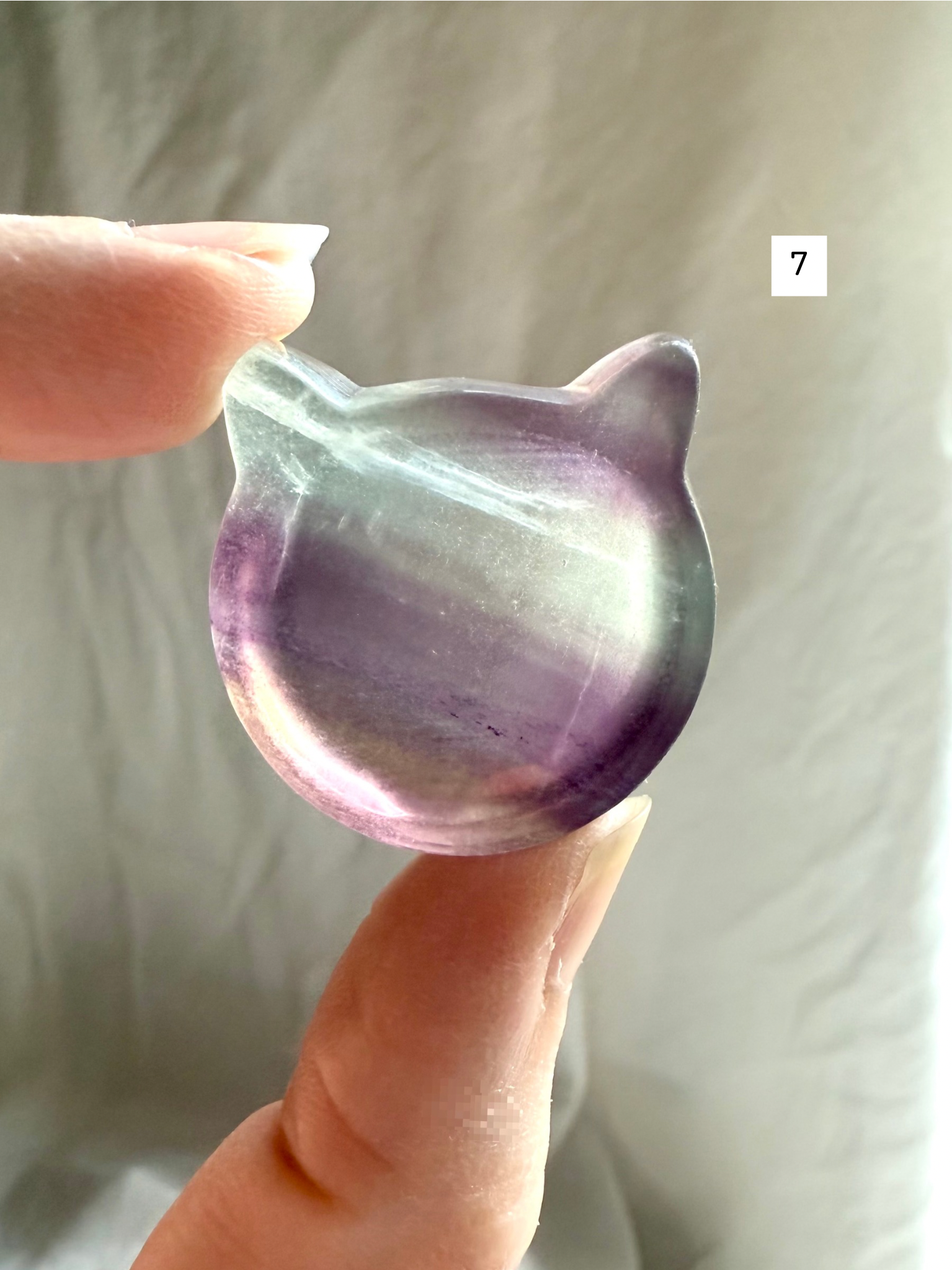 Fluorite cat-shaped crystal bowl held to the light – mini ring dish and jewelry holder