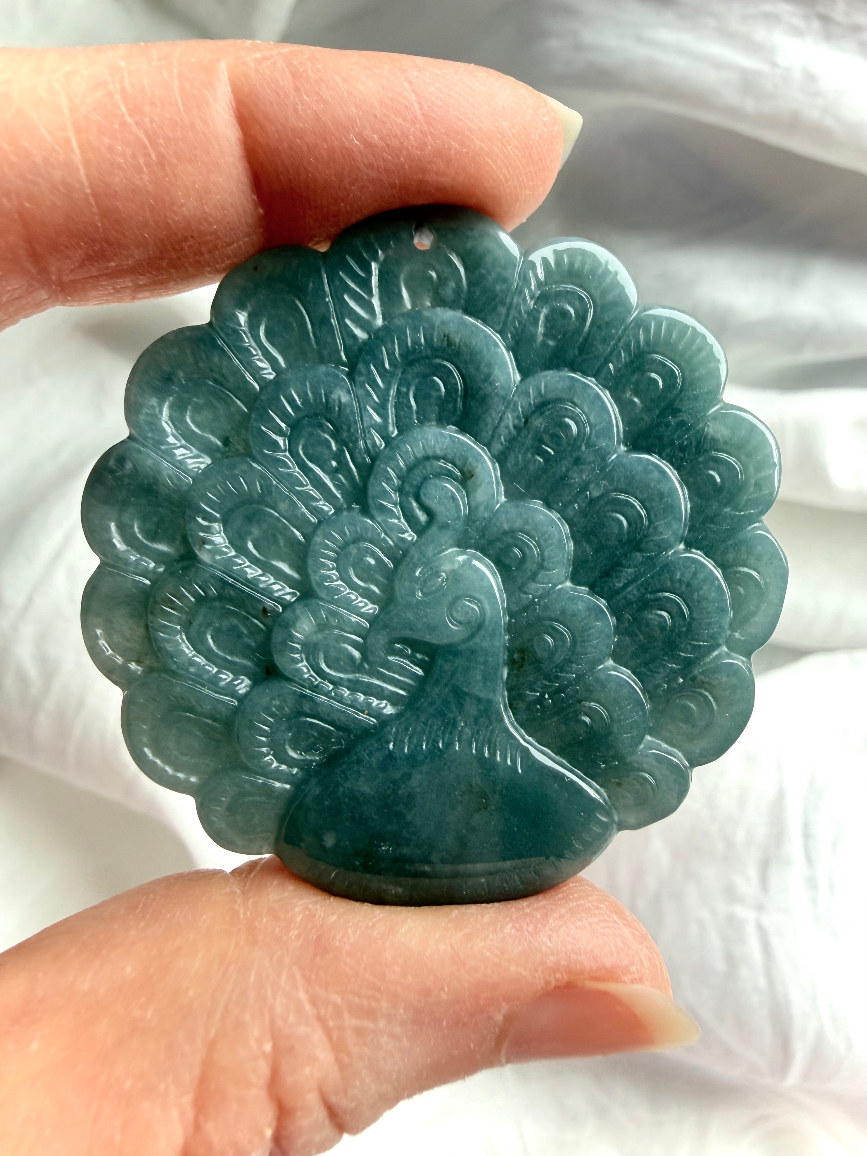 Blue Water Jade peacock medallion illuminated to reveal gentle translucence and natural marbling