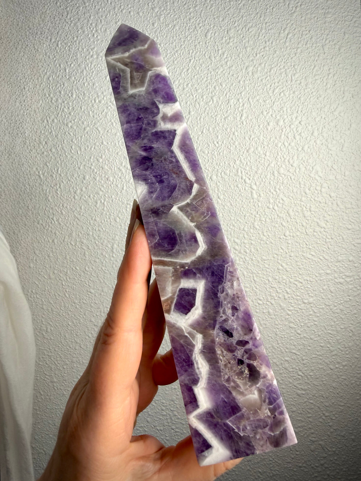 Dream Amethyst tower with striking purple and white Chevron Amethyst patterns, polished crystal point for intuition and spiritual growth