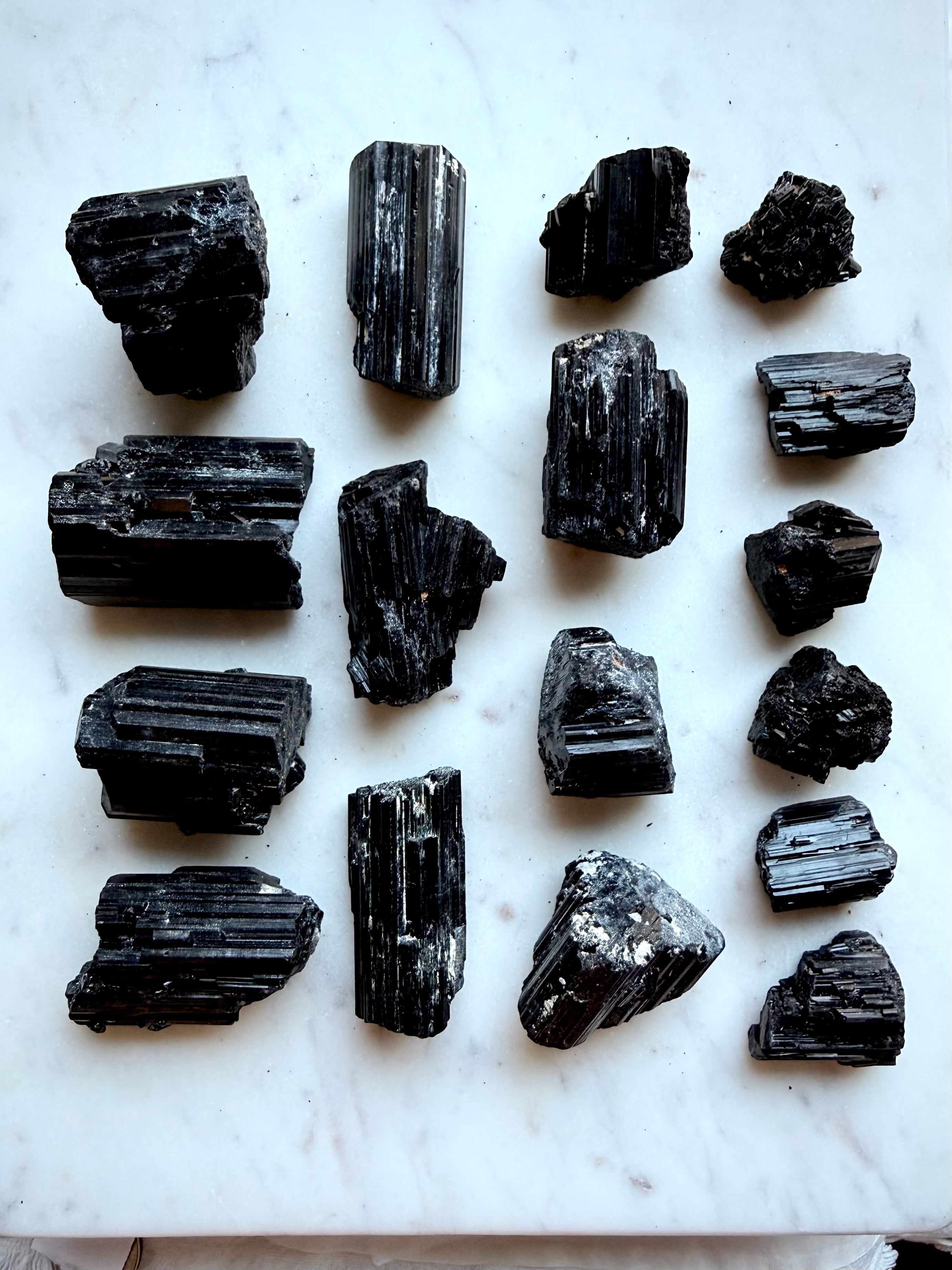 Raw Black Tourmaline chunks with glossy black crystalline striations and varied natural formations
