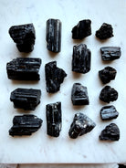 Raw Black Tourmaline chunks with glossy black crystalline striations and varied natural formations