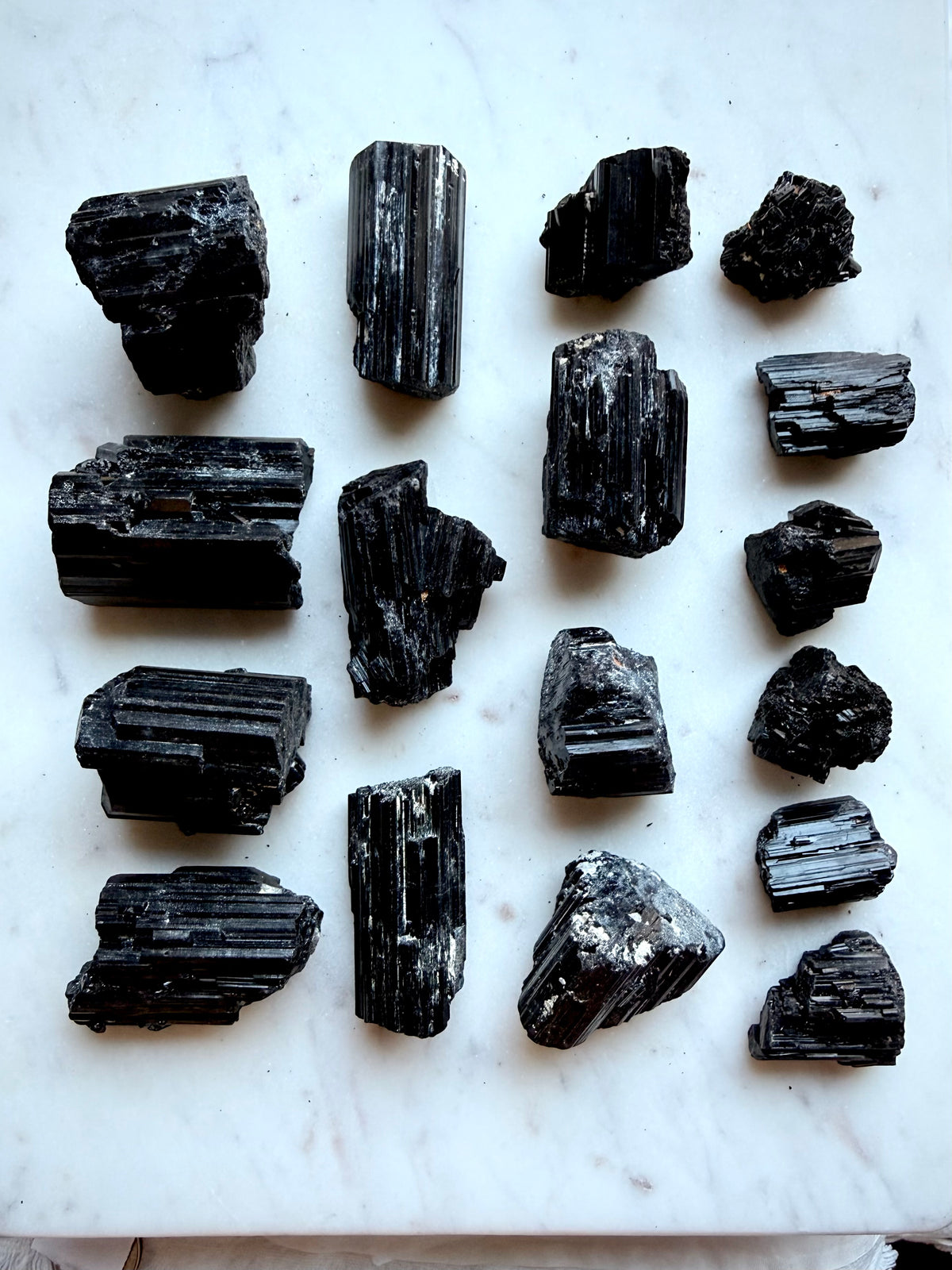 Raw Black Tourmaline chunks with glossy black crystalline striations and varied natural formations