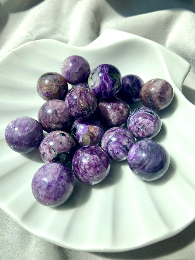 These rare mini Russian Charoite spheres have shimmering patterns in the stone.