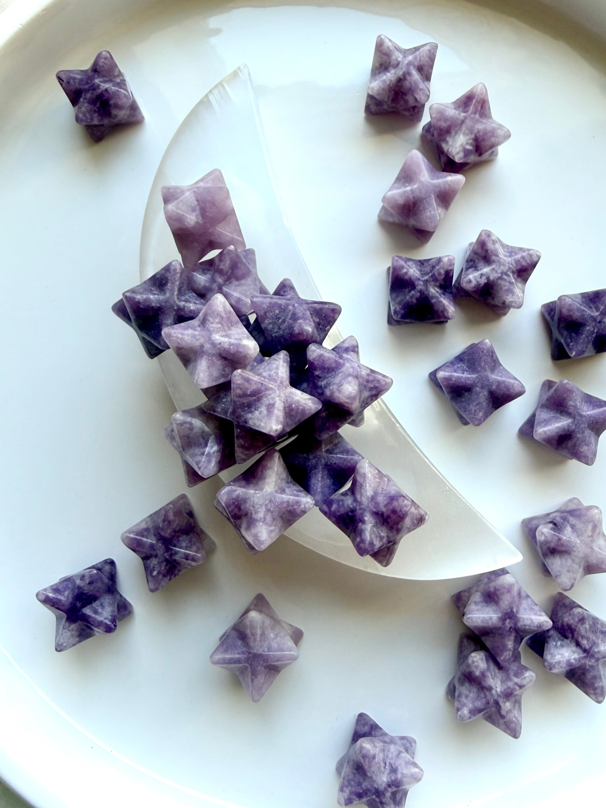 lepidolite merkaba stars shown in a selenite moon bowl, purple healing crystals for stress relief and emotional balance