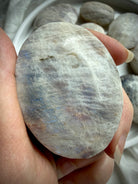 belomorite moonstone palm stone with blue flash, silvery shimmer, and natural sunstone inclusions in feldspar matrix