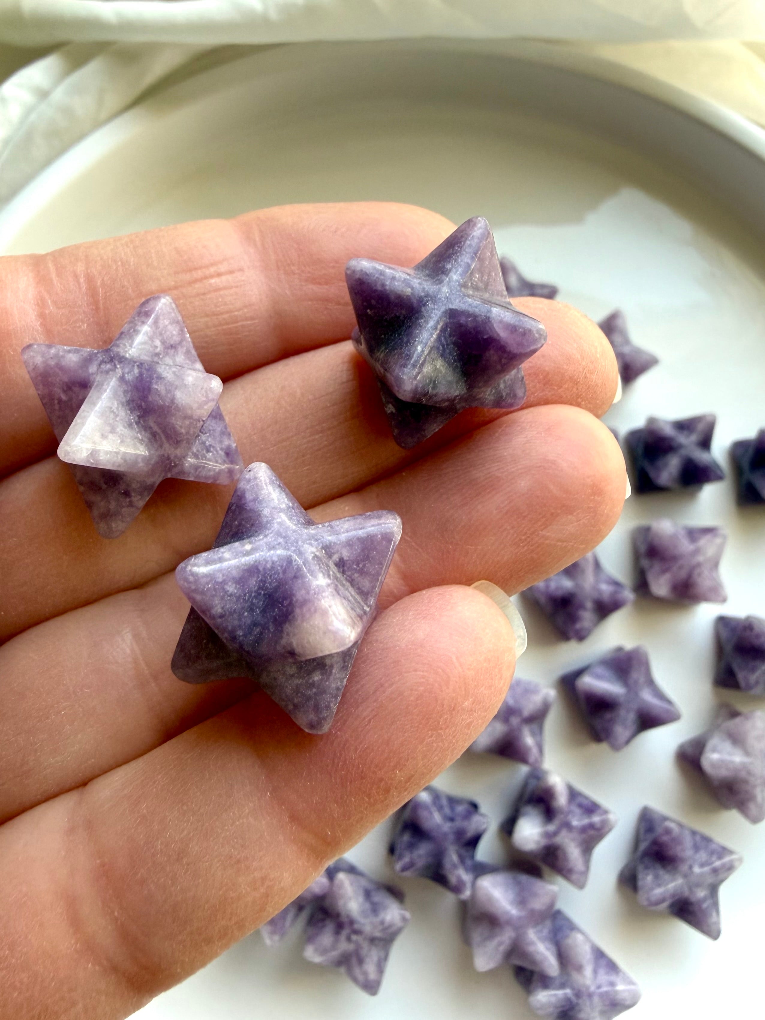 hand holding mini lepidolite merkaba star crystal, purple mica shimmer for anxiety relief and heart chakra healing