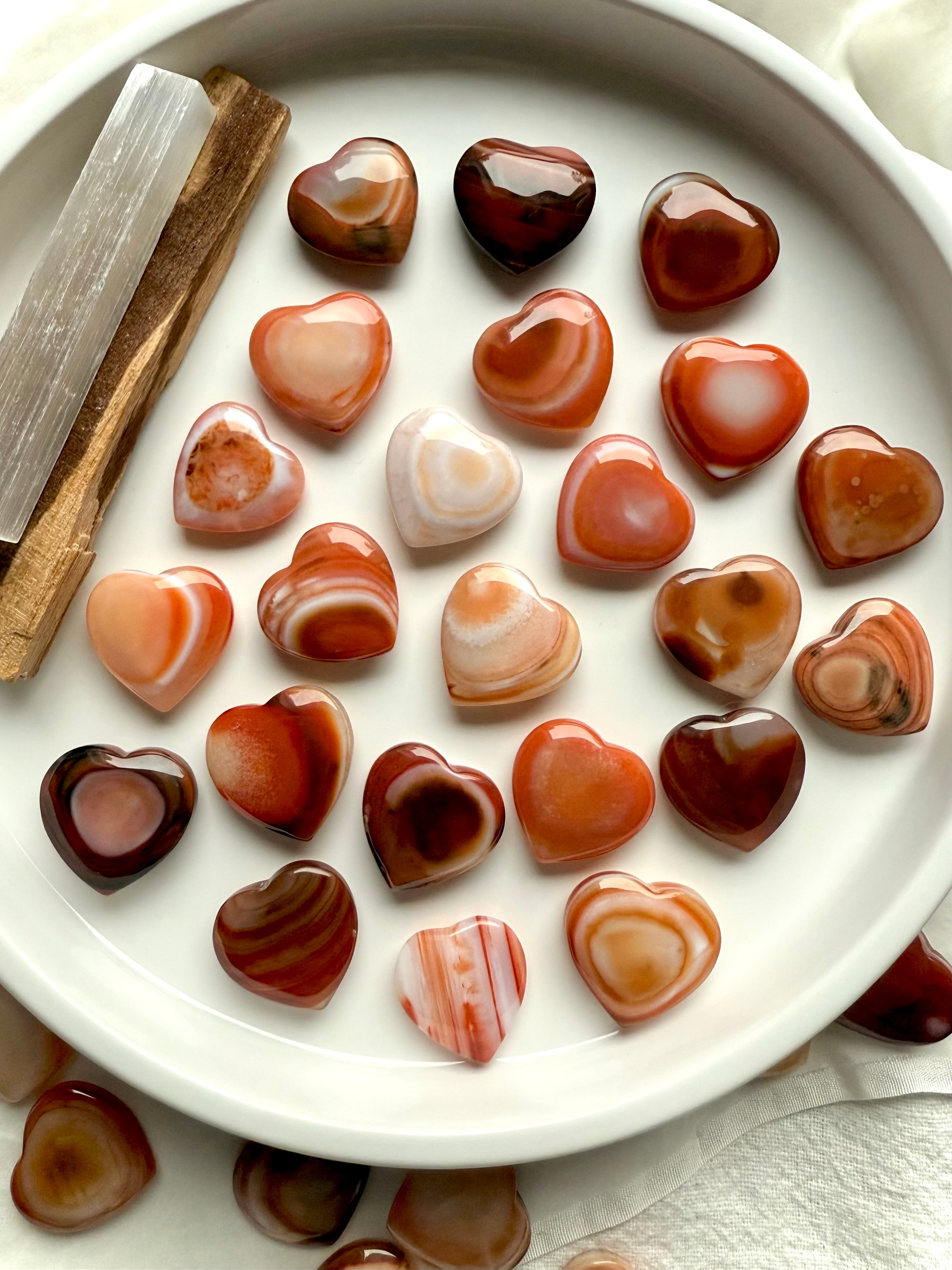 Mini Carnelian heart crystals styled on altar dish, vibrant sacral chakra stones for creativity, motivation, and sacred space décor