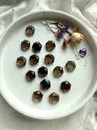Overhead of Natural Smoky Quartz hexagon crystal carvings with high polish and rich grounding tones