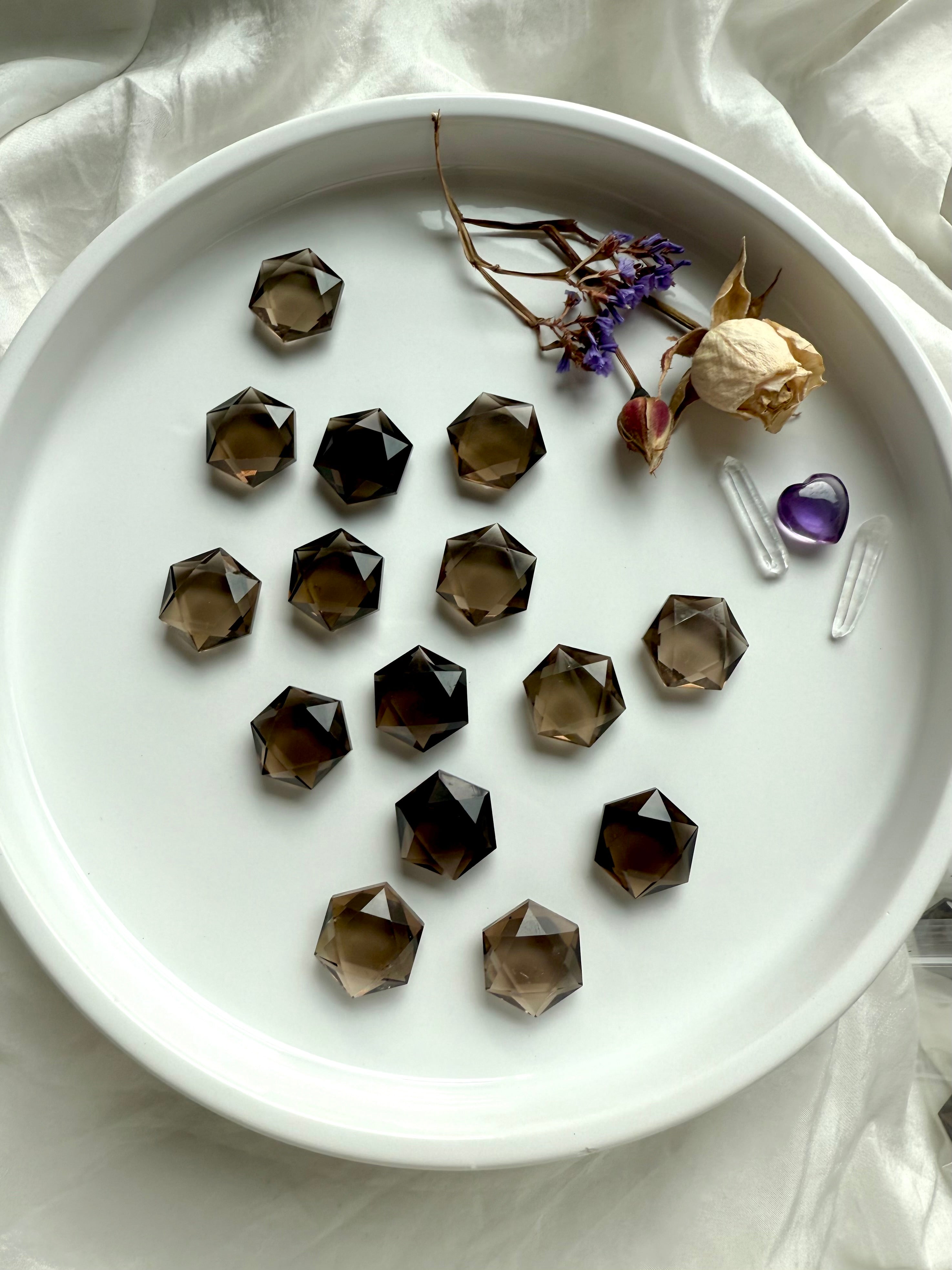 Overhead of Natural Smoky Quartz hexagon crystal carvings with high polish and rich grounding tones