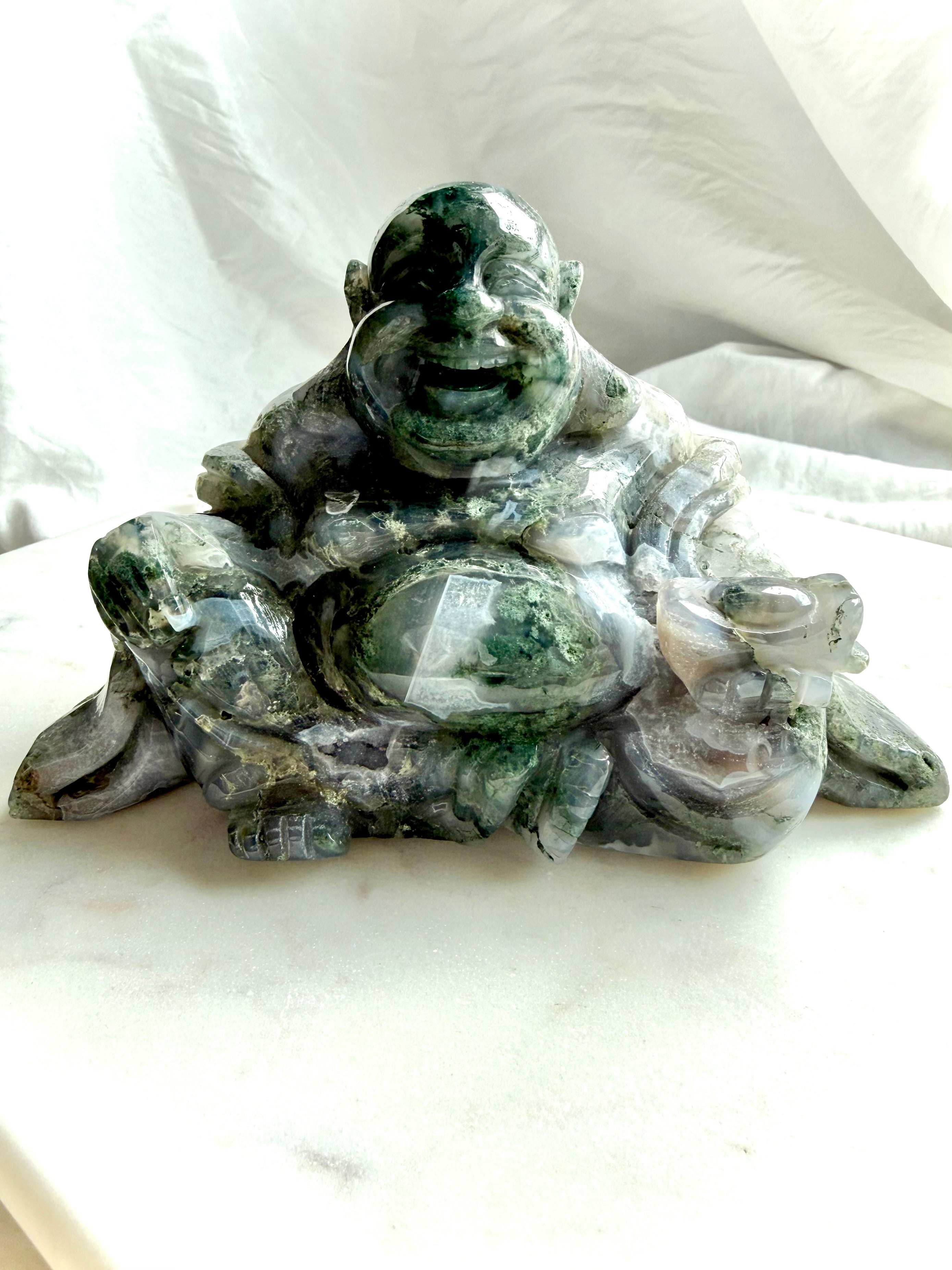 Front view of a Large Moss Agate Laughing Buddha crystal statue with scenic green inclusions