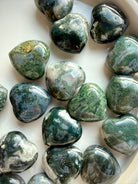 Polished Moss Agate hearts arranged for crystal healing and spiritual gifting, each with unique natural patterns
