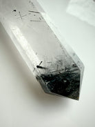 black tourmaline in quartz crystal point with polished facets and internal needle inclusions