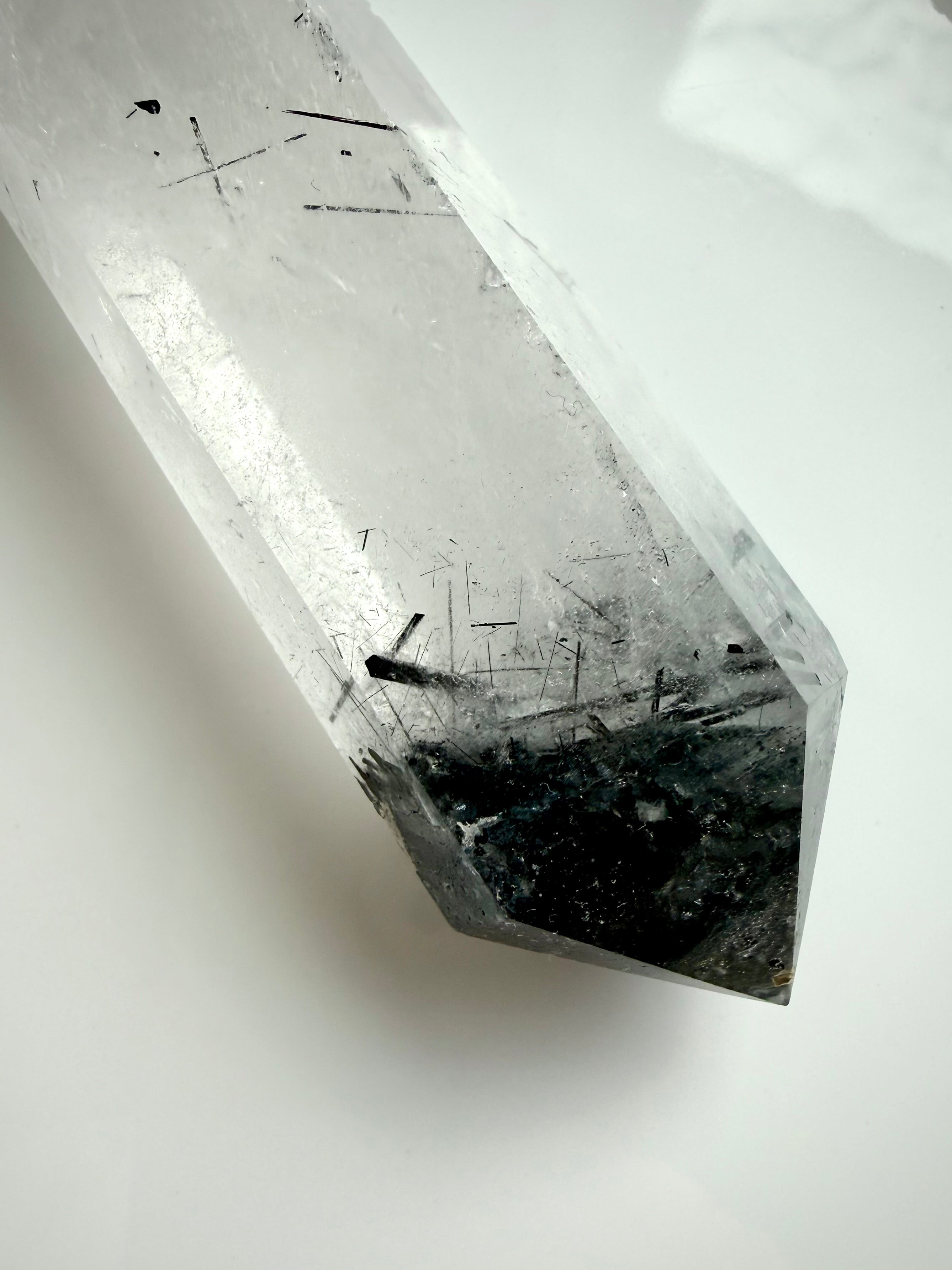 black tourmaline in quartz crystal point with polished facets and internal needle inclusions