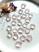 Mini Rose Quartz stars styled with dried flowers and Clear Quartz points for a crystal ritual or altar
