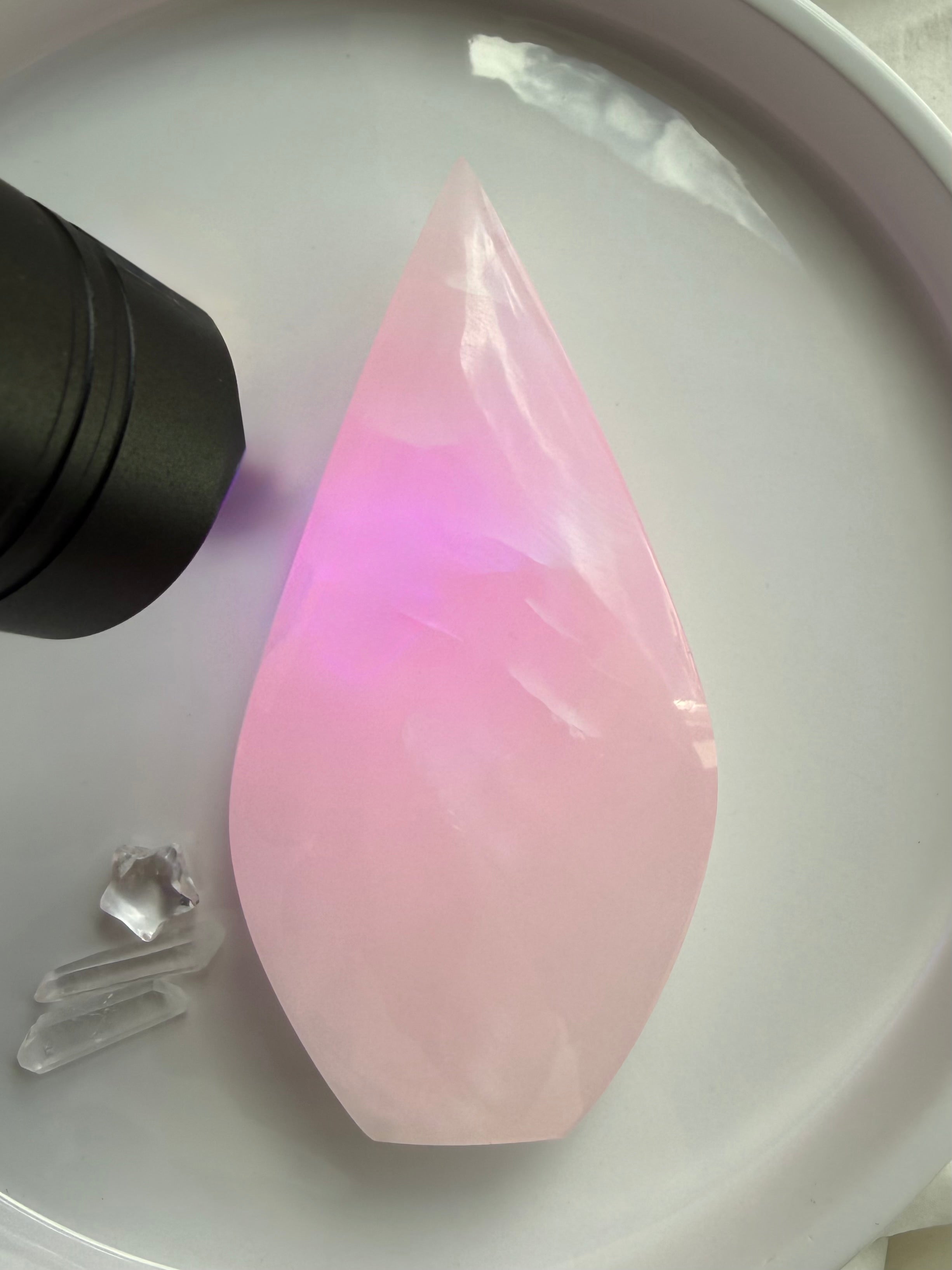 UV reactive Mangano Calcite flame glowing bright fluorescent pink under ultraviolet light from Pakistan