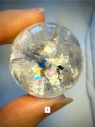 Macro photo of Rainbow Quartz sphere #2 with bold rainbow flash and internal clarity, perfect for chakra healing.