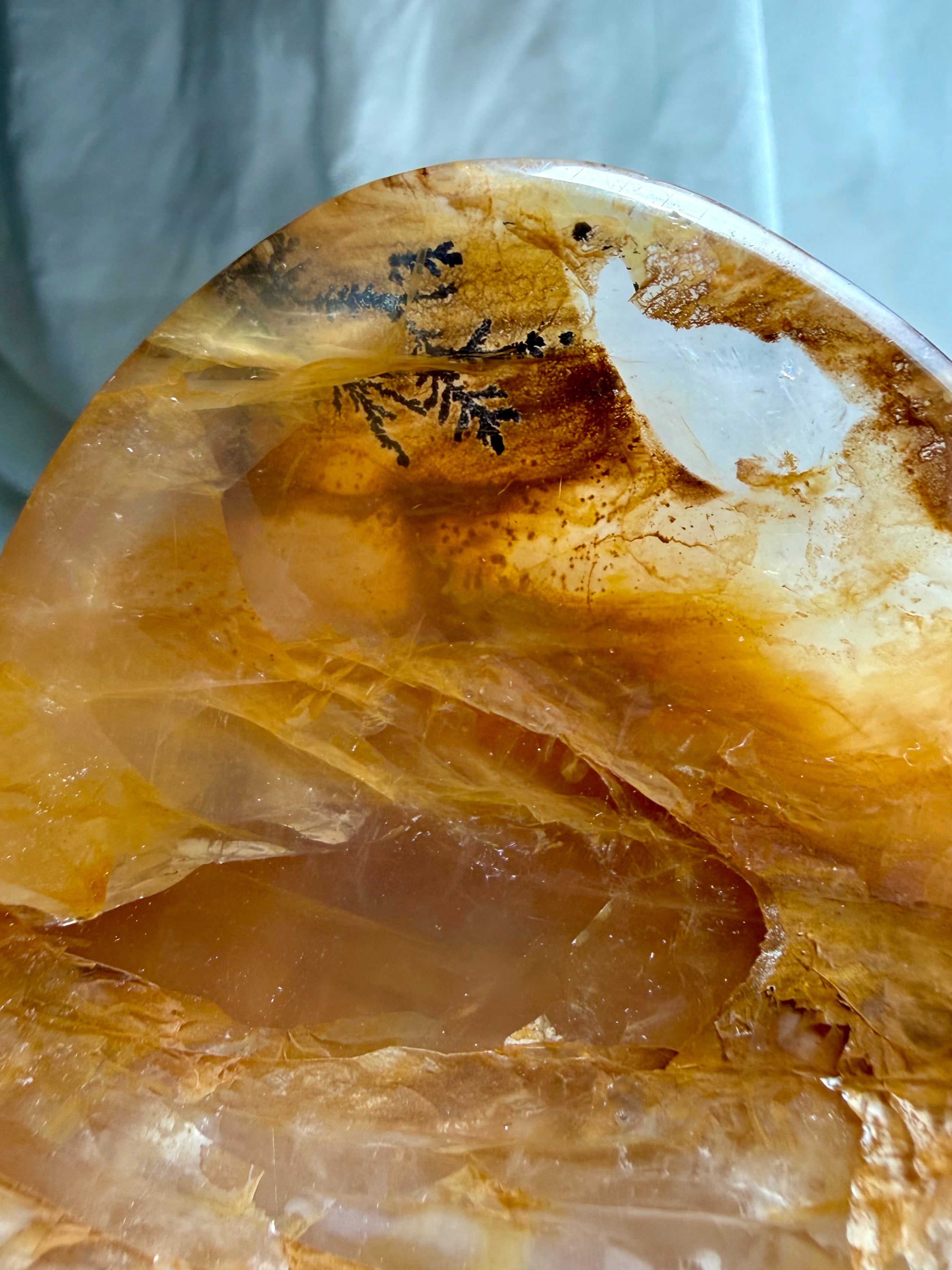 Close up Golden Healer crystal bowl with detailed dendritic formation and natural quartz banding