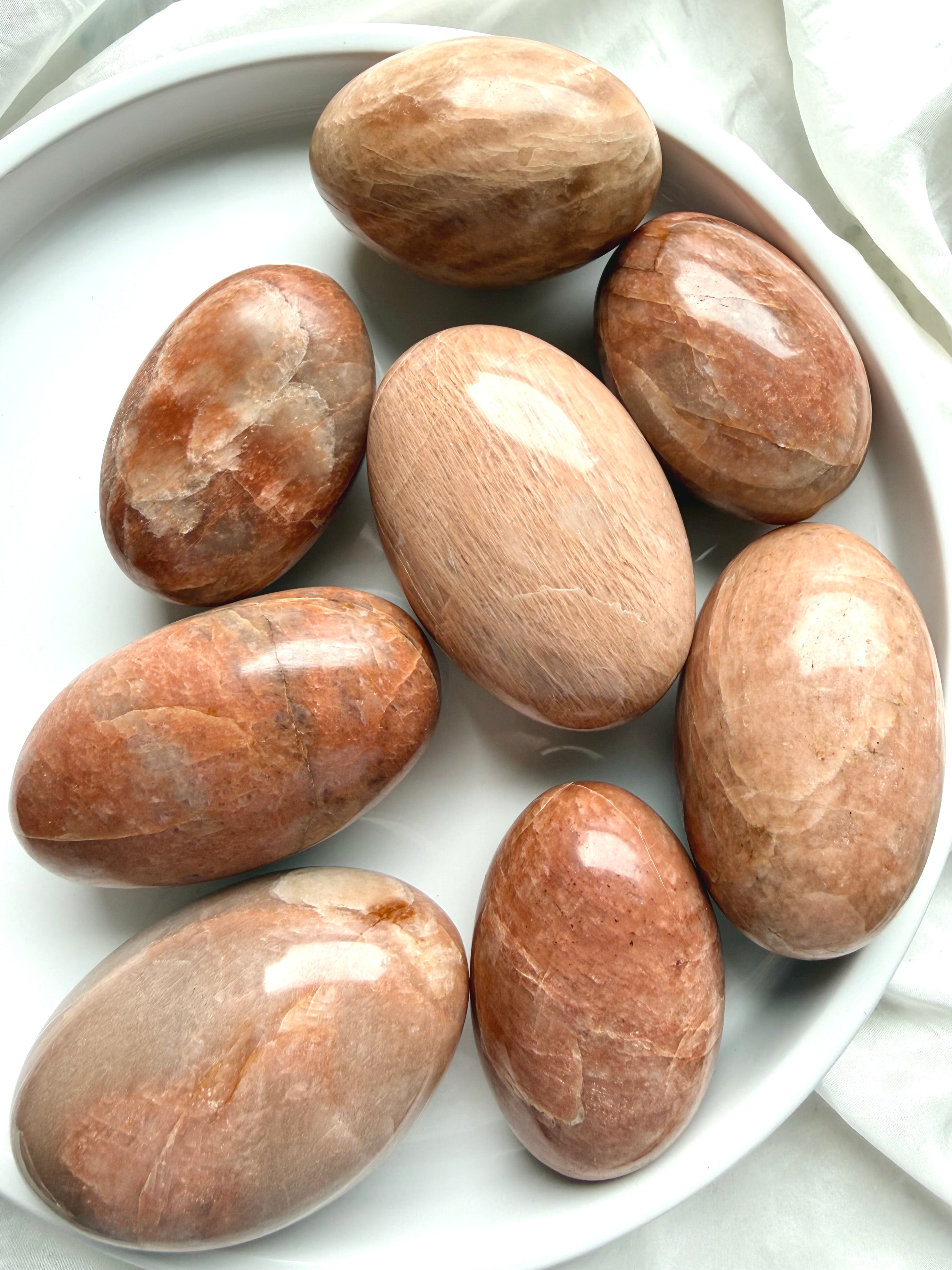 Large Peach Moonstone palm stones with warm peach and apricot tones for emotional healing, intuition, and feminine energy