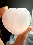 Large polished Mangano Calcite heart crystal with natural translucency for emotional healing and self love