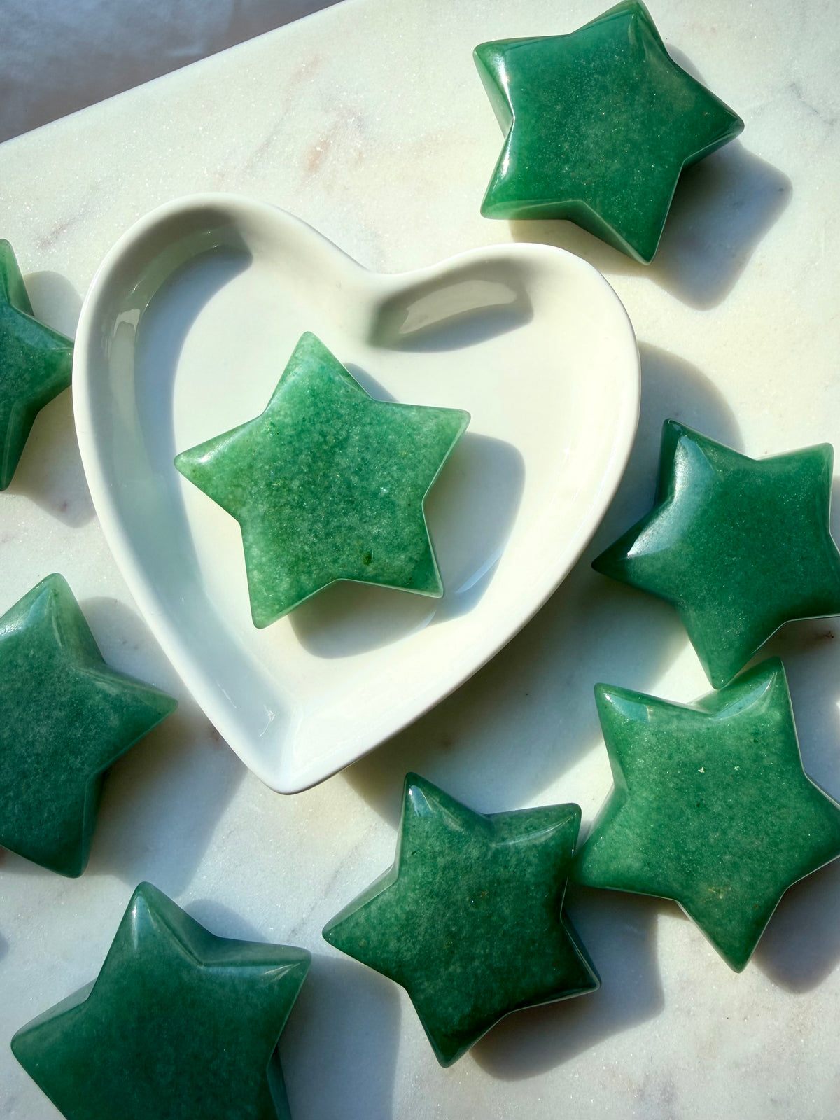 Green Aventurine star carvings displayed in a heart bowl, polished green crystals for abundance and good luck