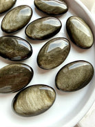 Golden Sheen Obsidian palm stones with luminous gold and bronze metallic shimmer for grounding and protection