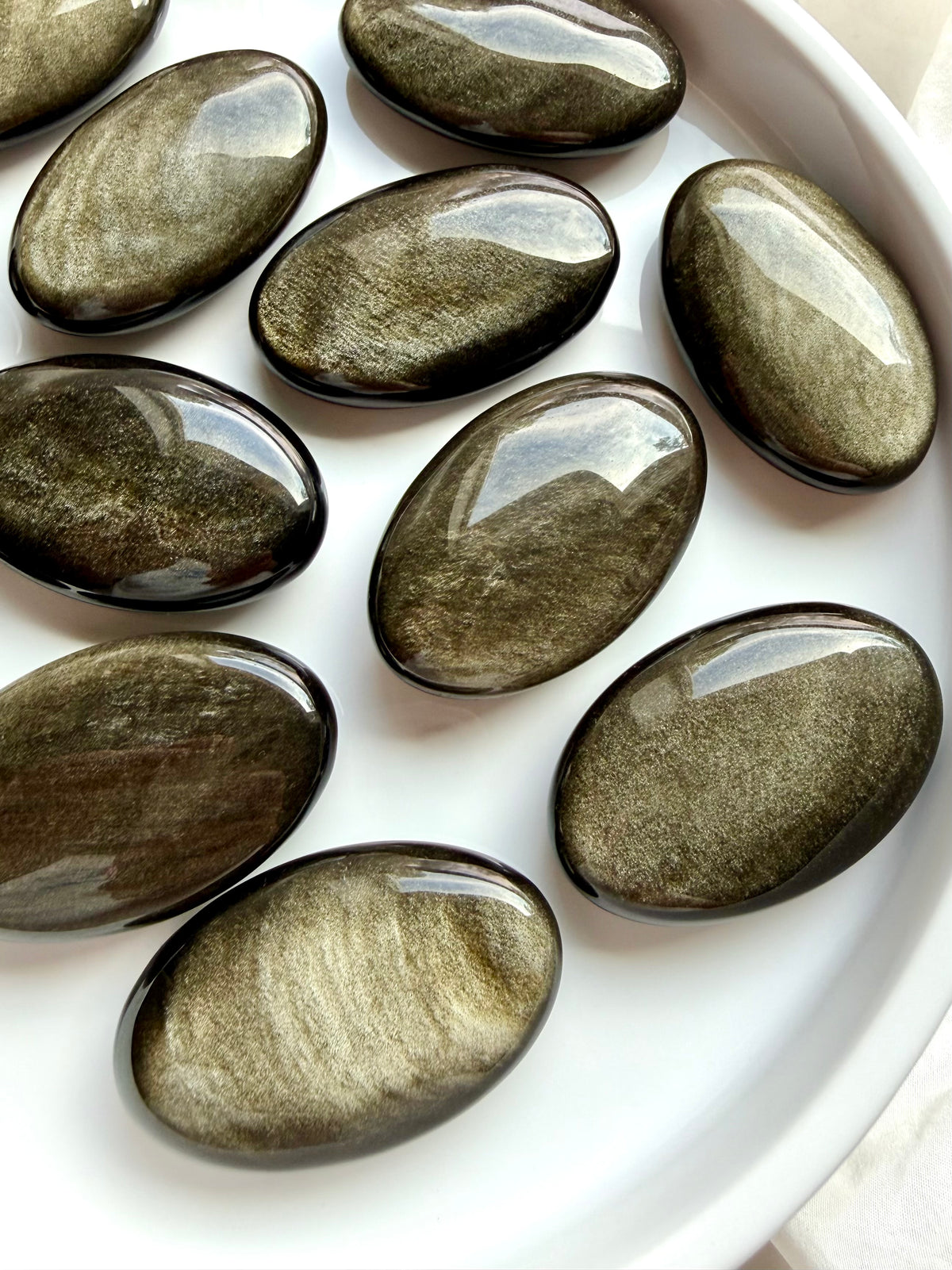 Golden Sheen Obsidian palm stones with luminous gold and bronze metallic shimmer for grounding and protection