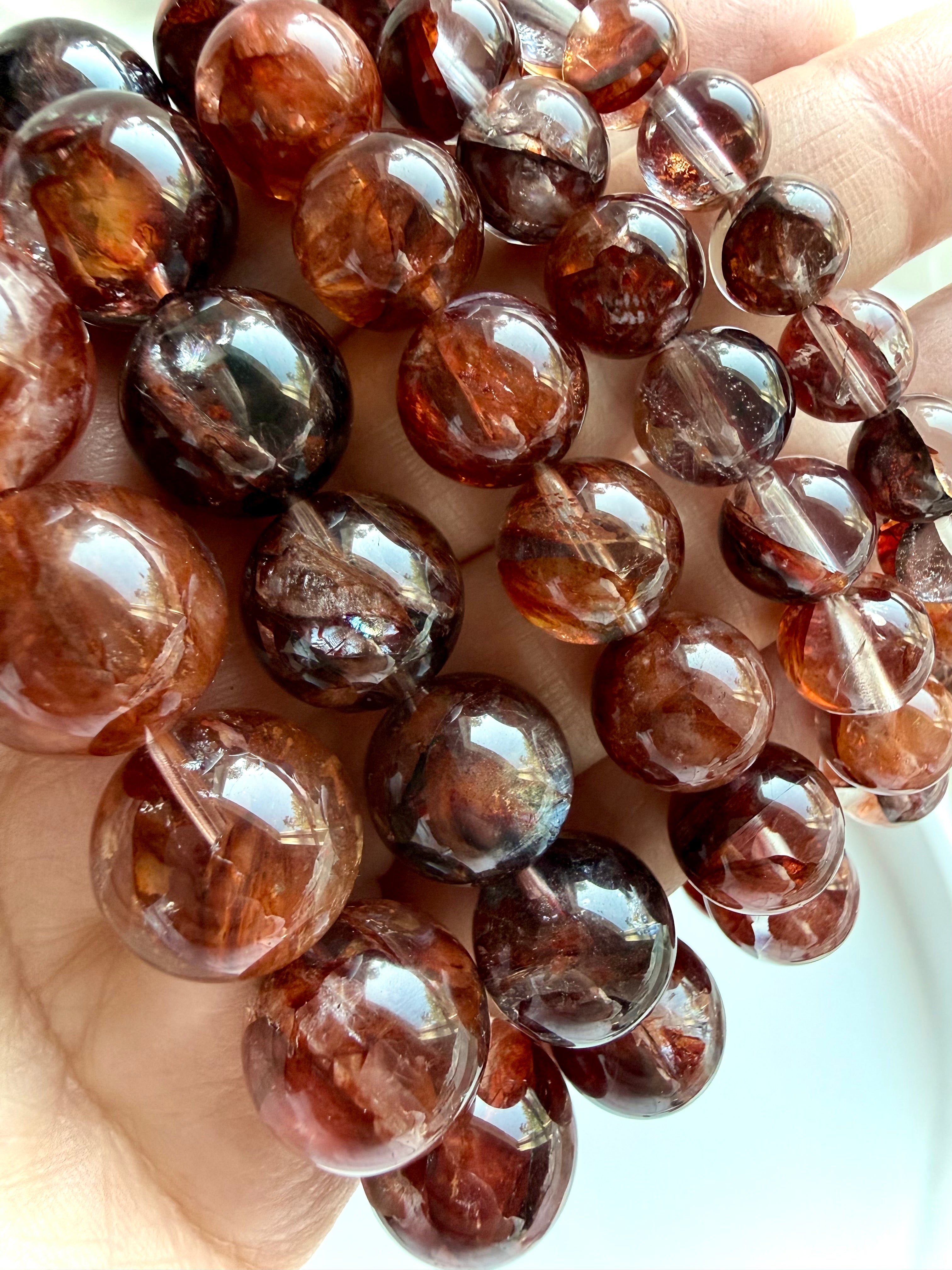 Dark Fire Quartz crystal bracelet showing rich burgundy, rust-red and smoky Hematoid Quartz beads with natural inclusions