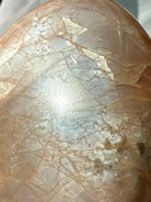 Close-up Peach Moonstone freeform showing luminous silver glow, golden Sunstone shimmer and warm peach feldspar tones