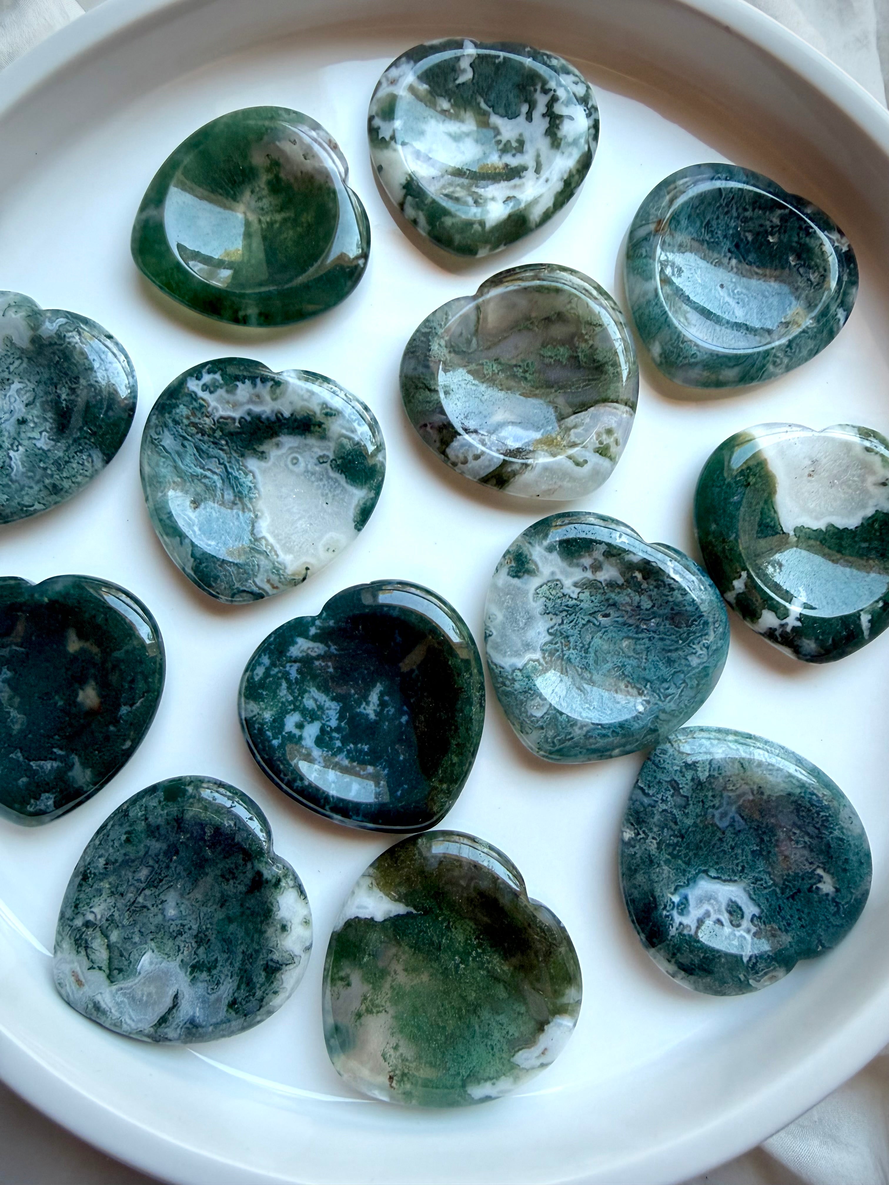 Assorted Moss Agate heart worry stones displaying unique green dendritic patterns and polished finish