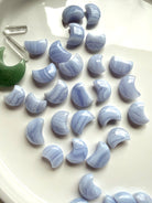 Blue Lace Agate crescent moon carvings in assorted sizes with soft blue color and natural white lace banding
