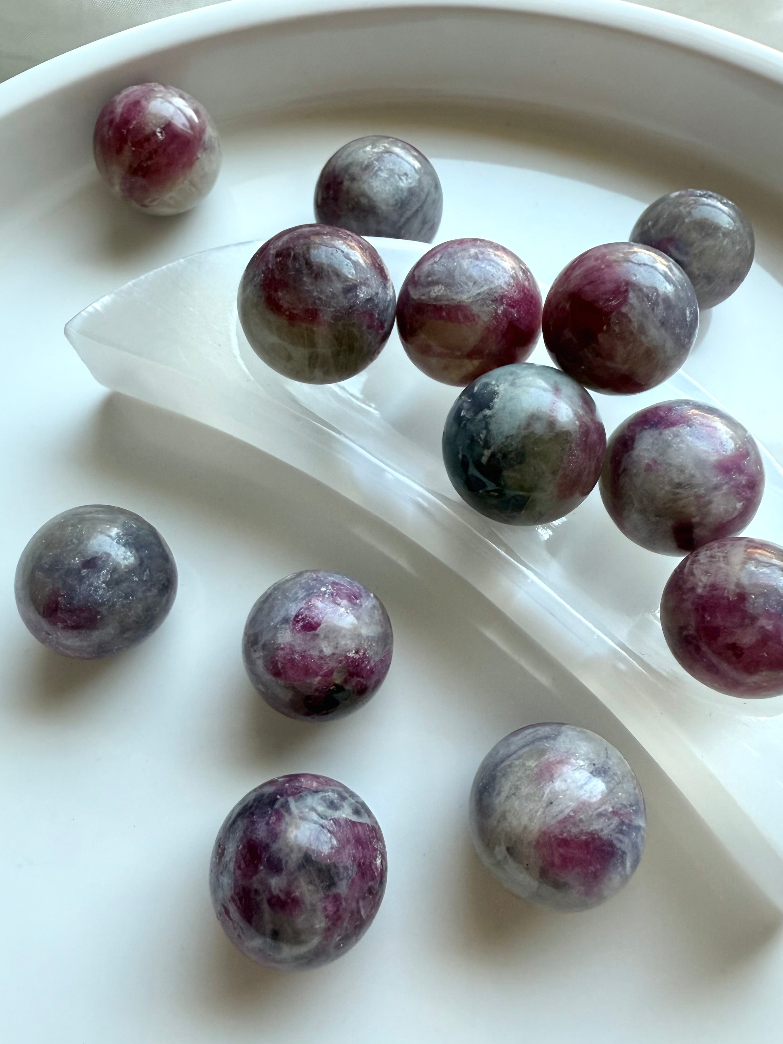 Mini Unicorn Stone crystal spheres displayed on a selenite crescent moon bowl for cleansing and charging