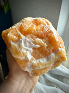 Handheld Orange Calcite specimen with warm uplifting energy and substantial display presence