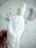 White Jade Quan Yin statue with lotus base displayed in a peaceful meditation setting