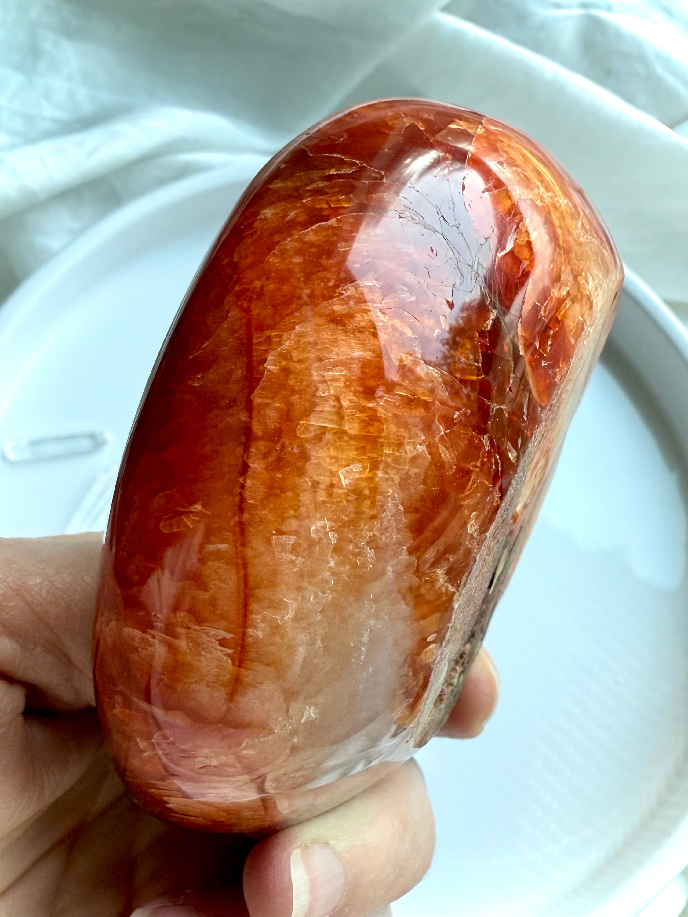 Side profile of sculpted Carnelian bowl with glowing orange hues – hand-carved gemstone decor bowl