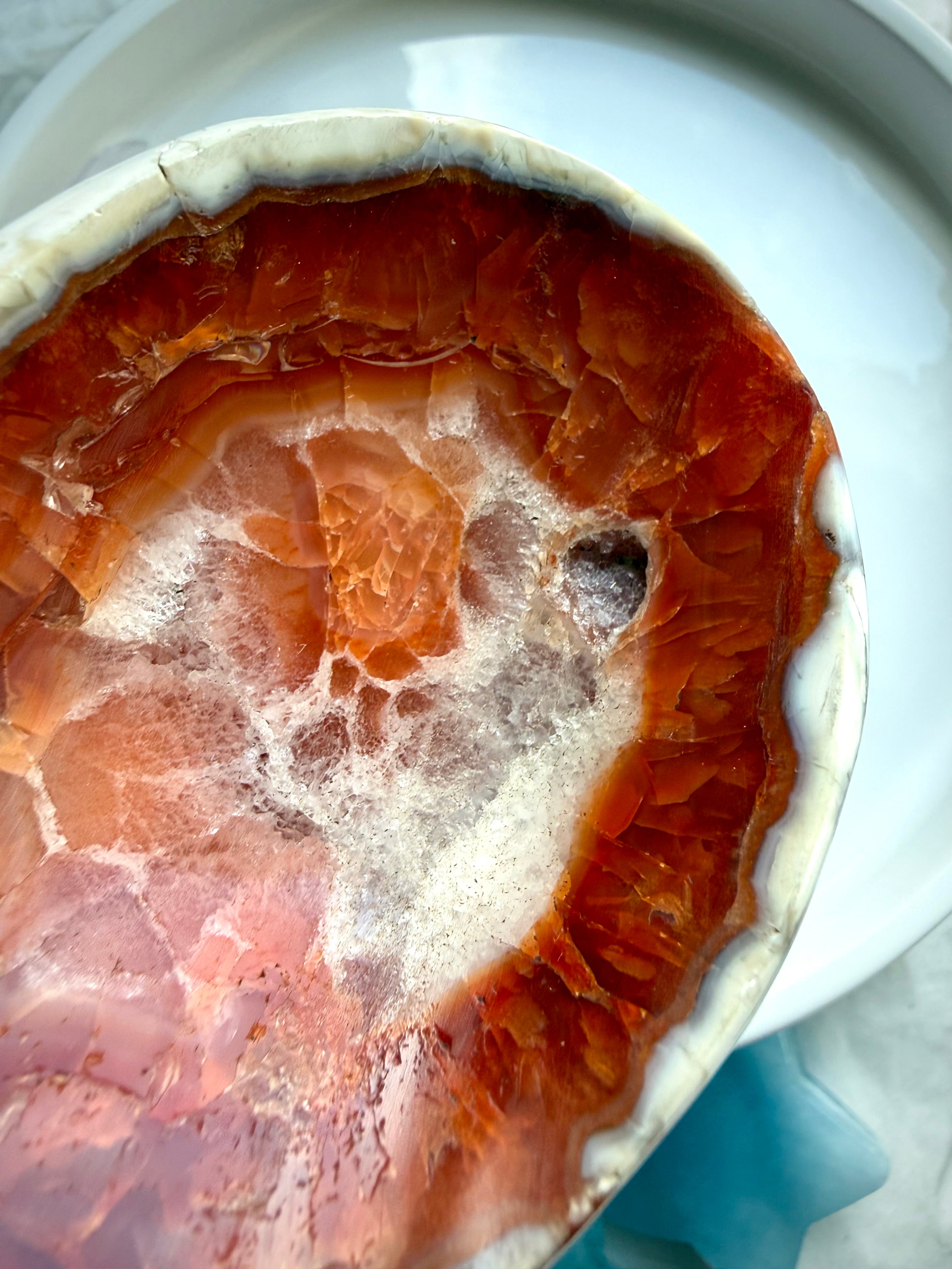 detailed view of polished carnelian stone dish with banding and internal inclusions