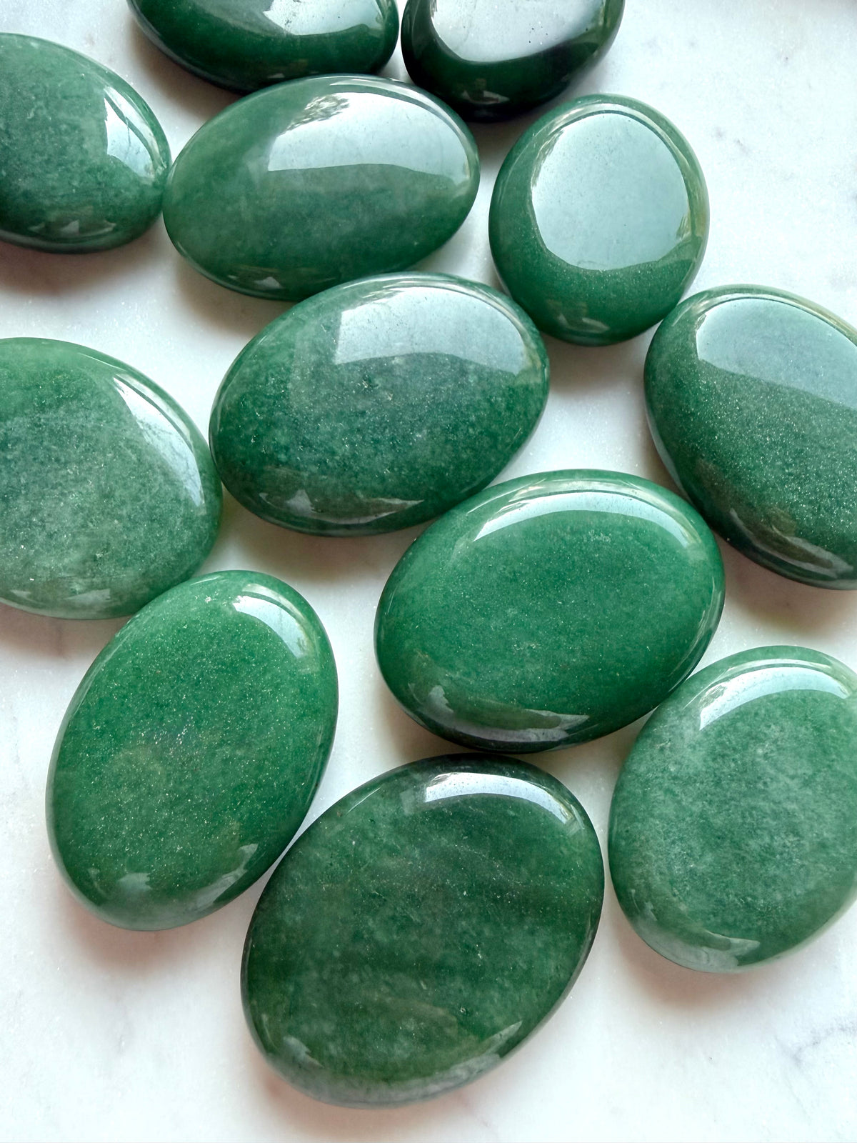 Natural Green Aventurine palm stones in soft sage to forest green with varied color and mineral shimmer