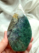 Hand-held Moss Agate flame showing vibrant green chlorite formations in translucent agate matrix, one of a kind crystal carving