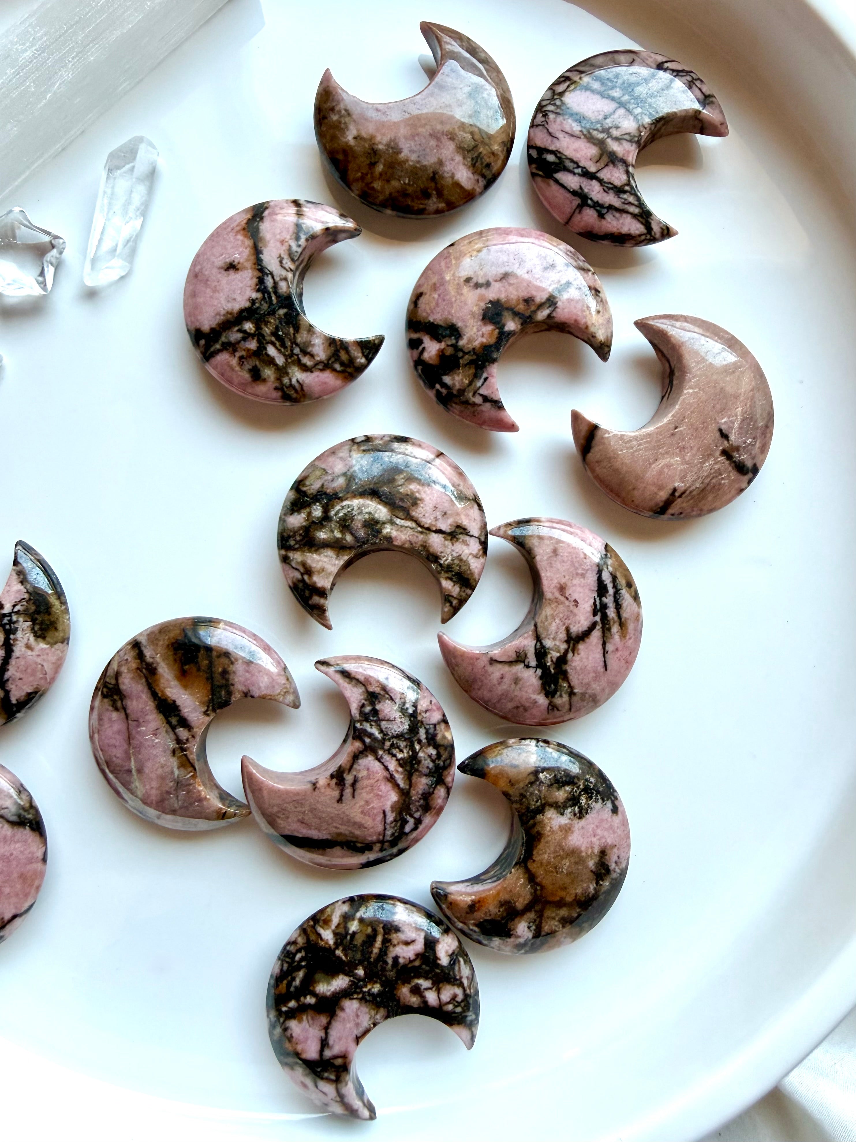 Rhodonite crescent moon carvings with natural pink and black veining for emotional healing, self-love and Heart Chakra energy