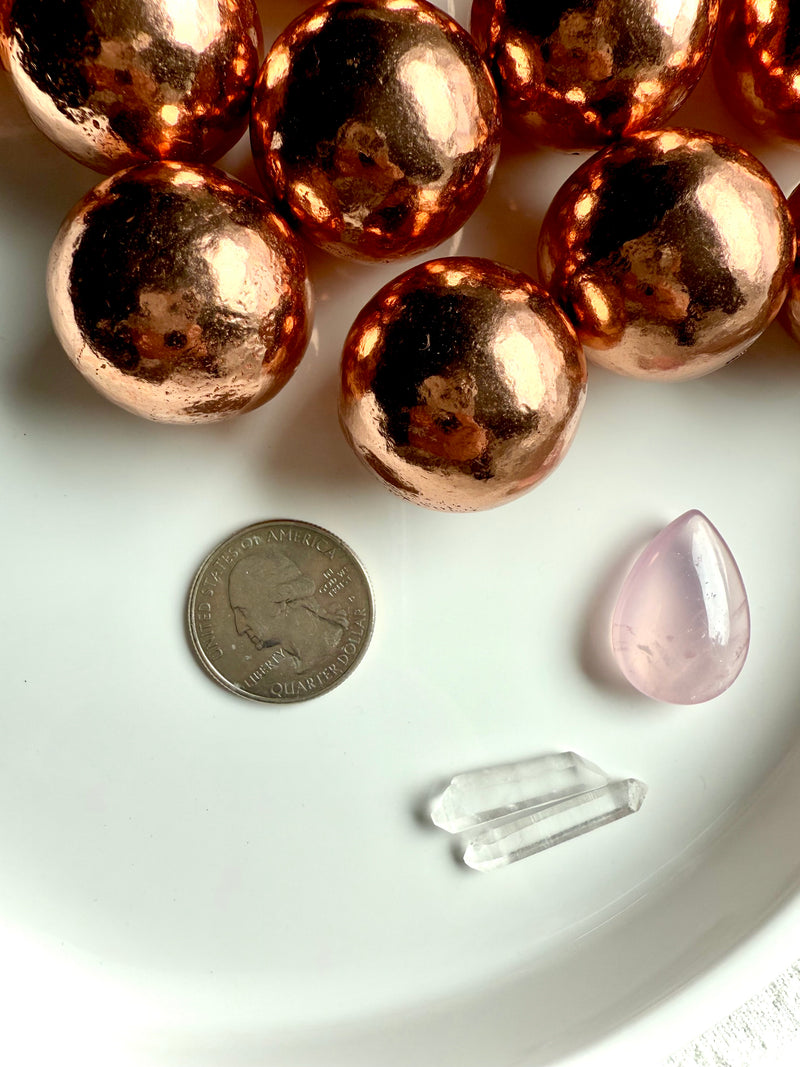 30 mm Michigan copper spheres shown with a quarter for scale