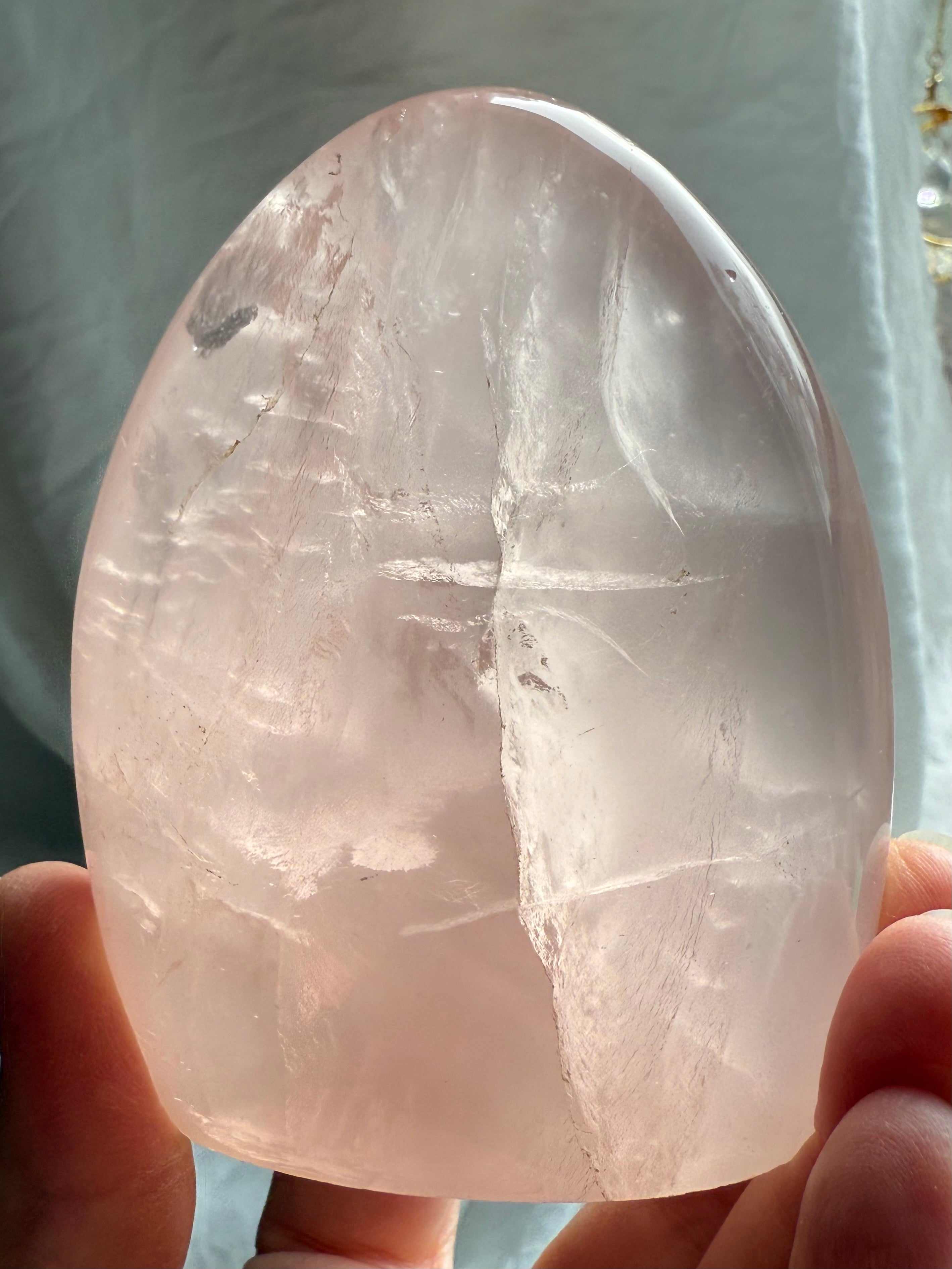 Transparent pink Rose Quartz crystal freeform with dreamy glow and polished sculptural shape