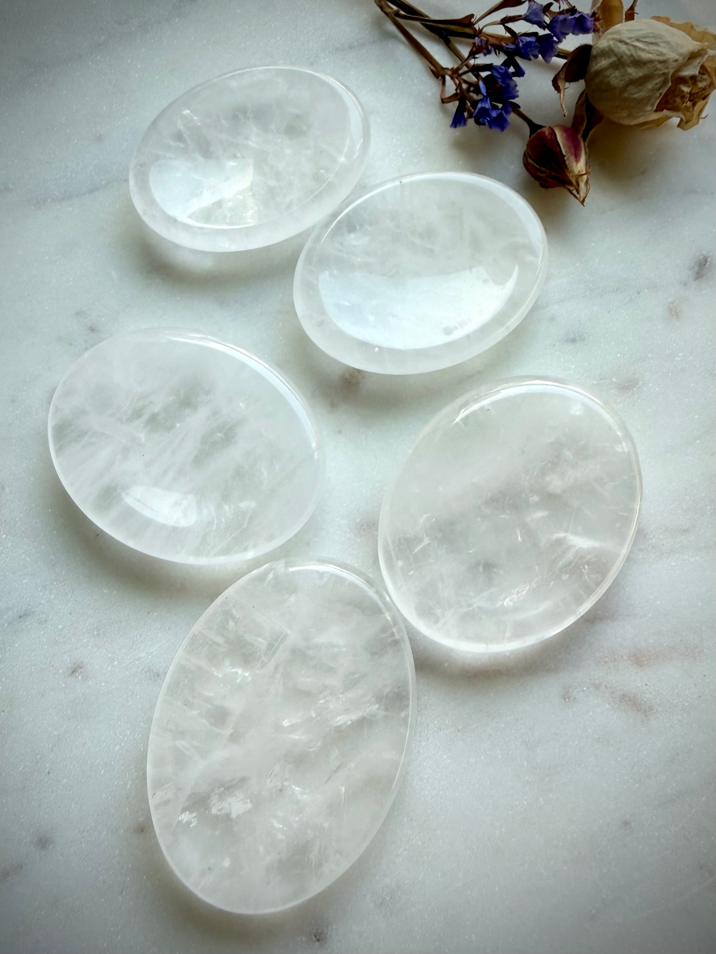 clear quartz oval worry stones on marble surface for clarity focus and calming energy