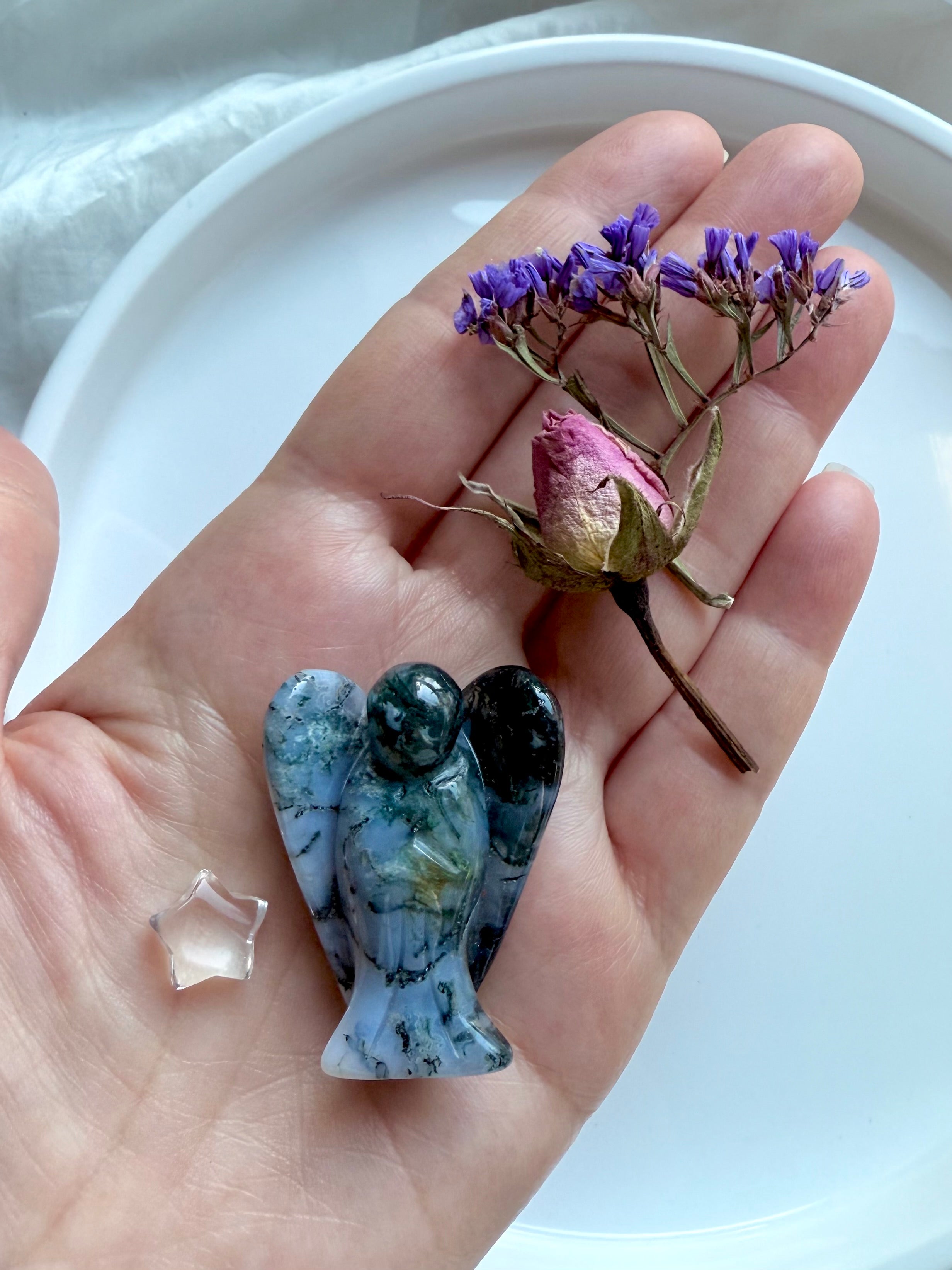 Moss Agate crystal angel figurine, tiny clear quartz star, and mini dried flower bouquet resting on open hand – grounding healing gift set