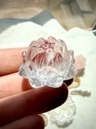 Clear Quartz lotus carving held in hand with luminous polished petals and natural internal veils