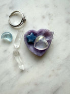 Mini Lepidolite heart bowl used as a crystal jewelry dish with tiny crystals for whimsical vanity décor