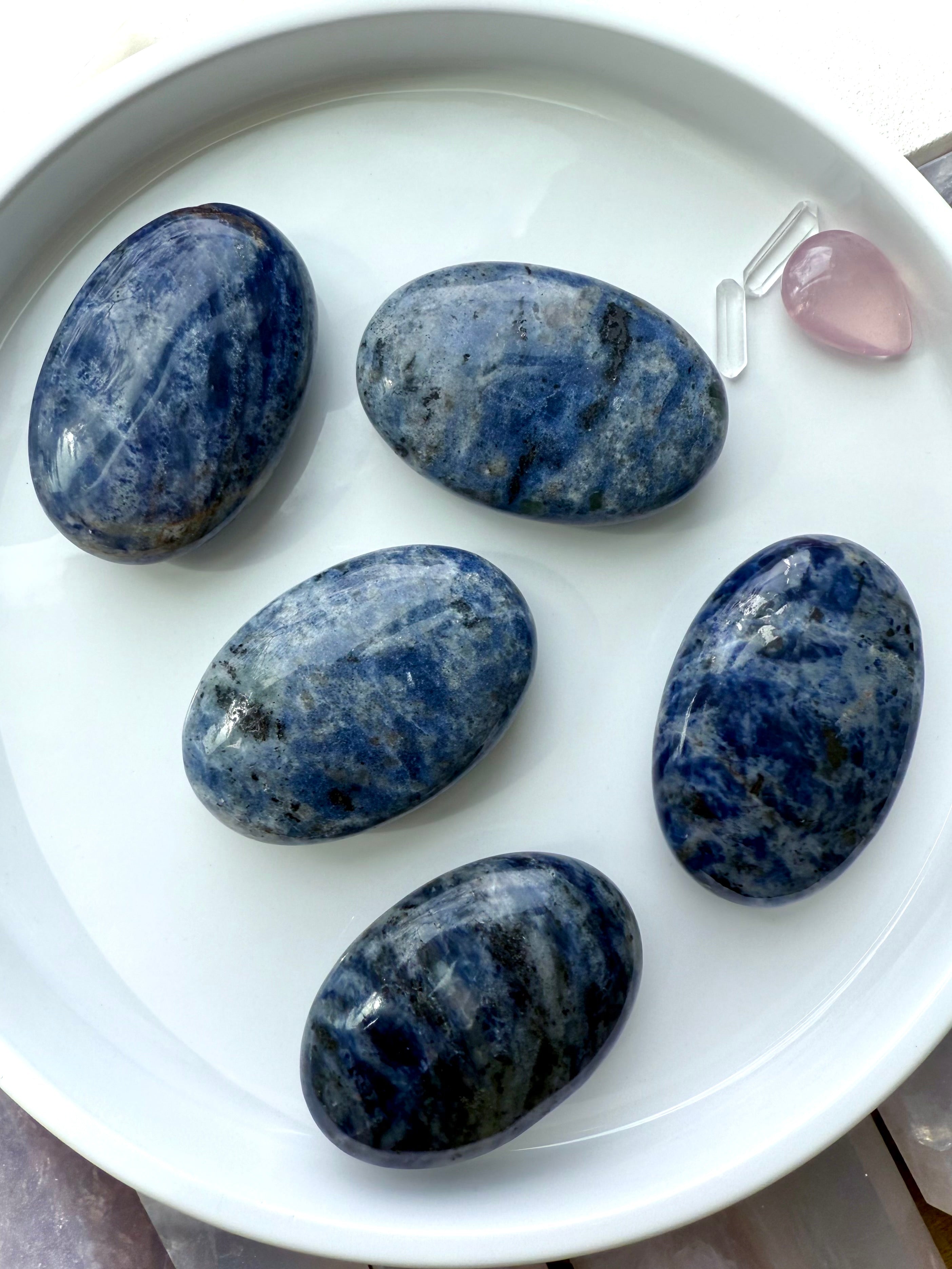 An assortment of high quality blue Sodalite Palmstones for Throat Chakra clearing and activation