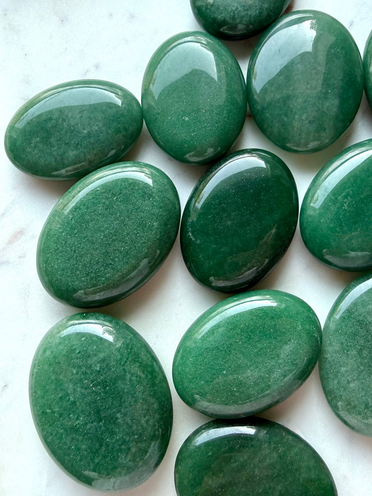 Green Aventurine palm stones with natural green color, glossy polish, and subtle aventurescence