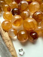 golden healer quartz mini spheres arranged on white surface with natural golden coloration