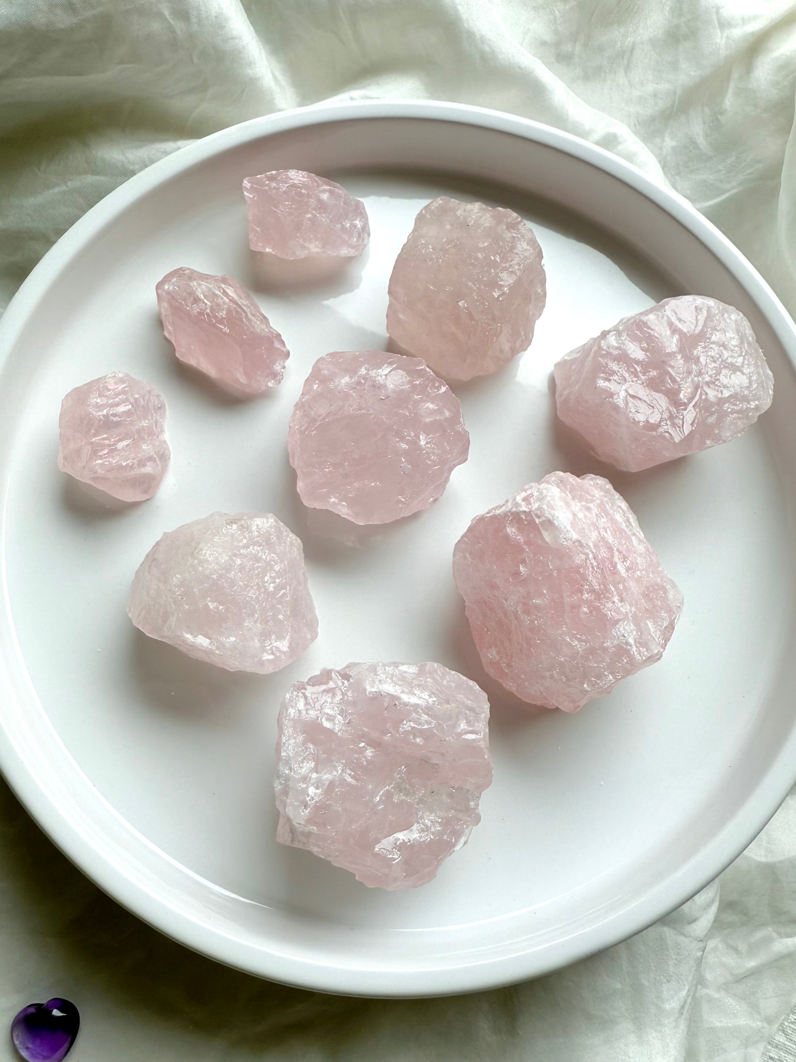 Raw Rose Quartz crystal chunks from Madagascar in neat rows, healing Heart Chakra stones for love & emotional balance